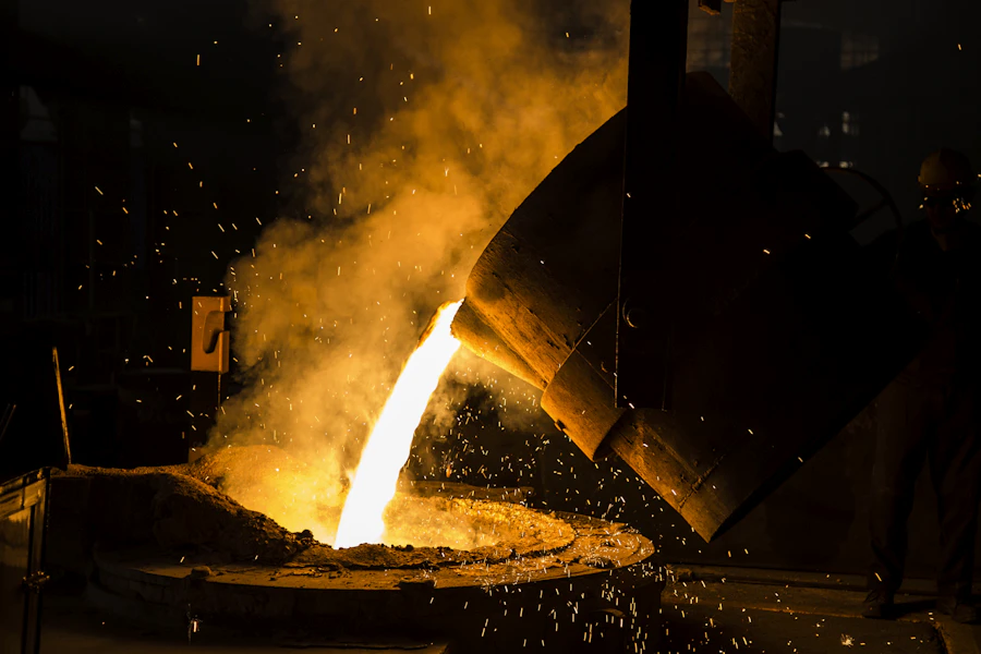 Worker handling metal components in a manufacturing facility
