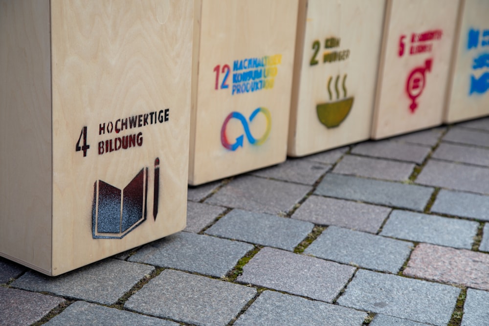 a row of wooden boxes sitting on top of a sidewalk