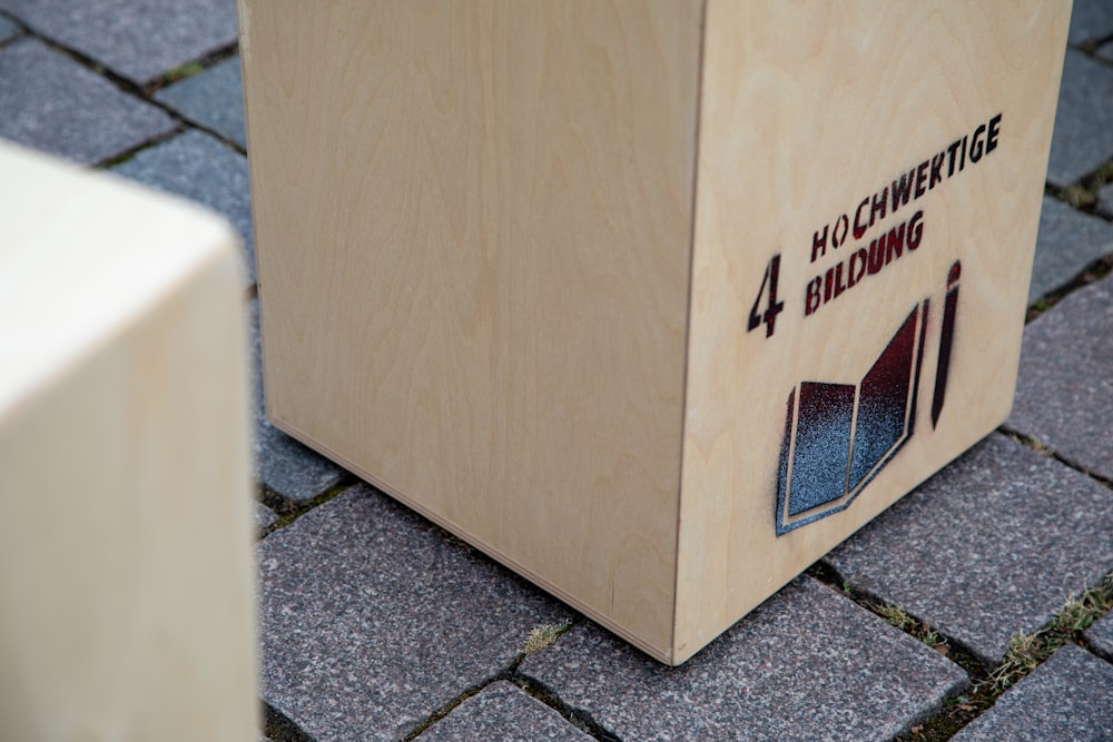 a wooden box sitting on top of a sidewalk