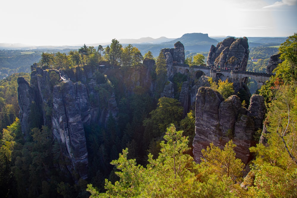 a scenic view of a mountain with a bridge in the middle of it