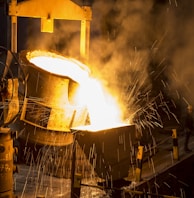 a large piece of metal being poured onto a machine