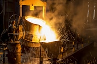 a large piece of metal being poured onto a machine