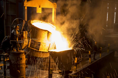 a large piece of metal being poured onto a machine