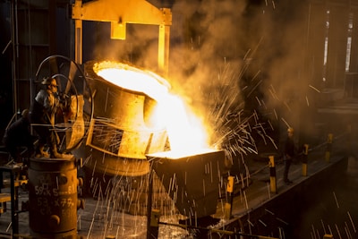 a large piece of metal being poured onto a machine
