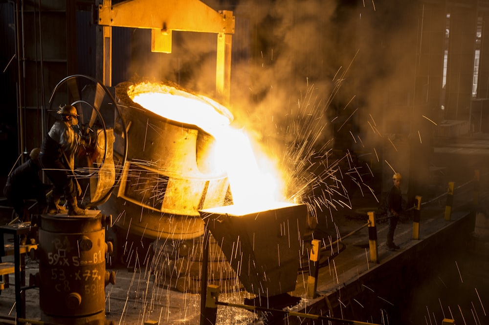 a large piece of metal being poured onto a machine