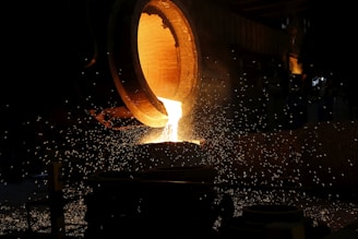 a large piece of metal being poured into a container