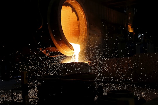 a large piece of metal being poured into a container