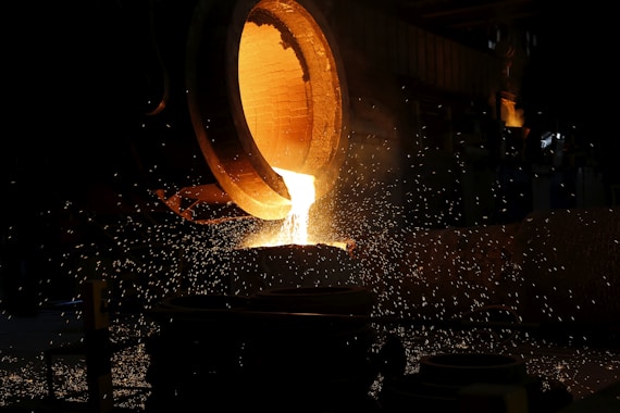 a large piece of metal being poured into a container