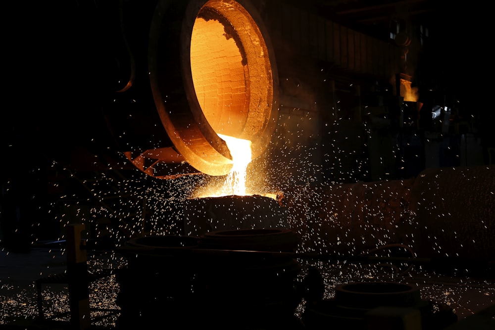 a large piece of metal being poured into a container