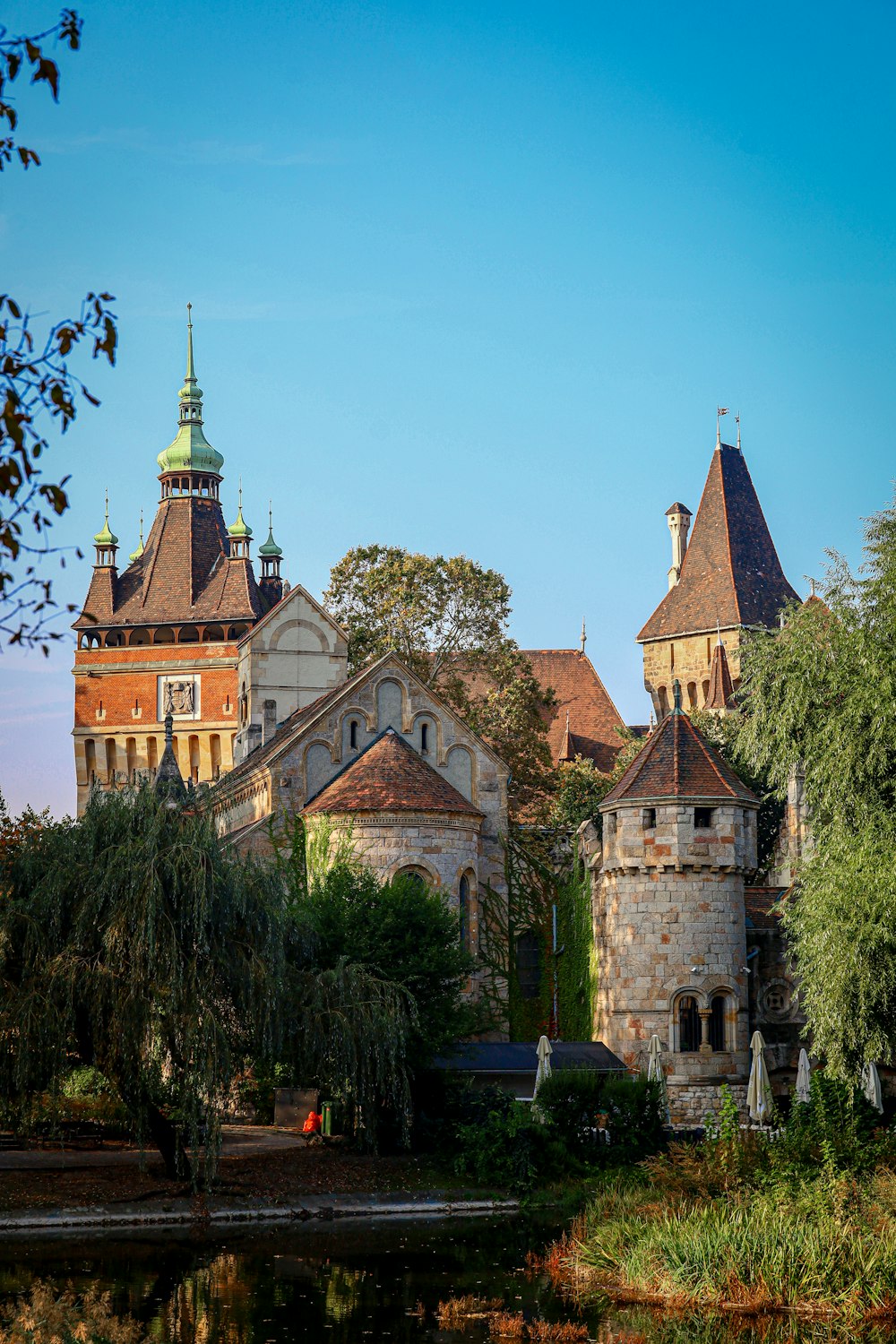 a castle with a pond in front of it