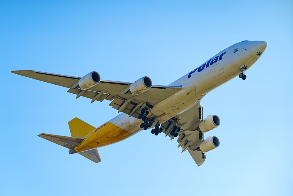 a large jetliner flying through a blue sky