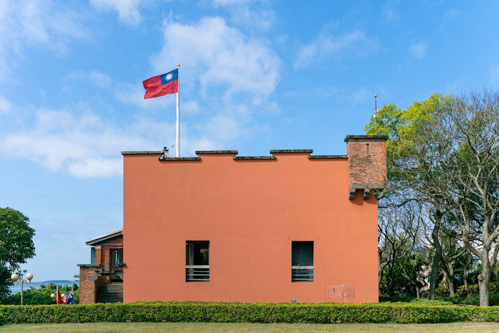a red building with a flag on top of it