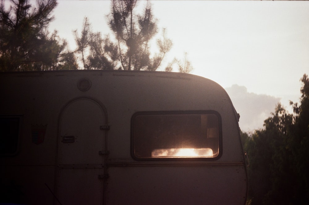 the sun is shining through the window of a camper