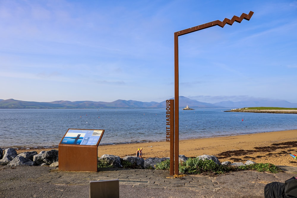 a man sitting on a bench next to the ocean