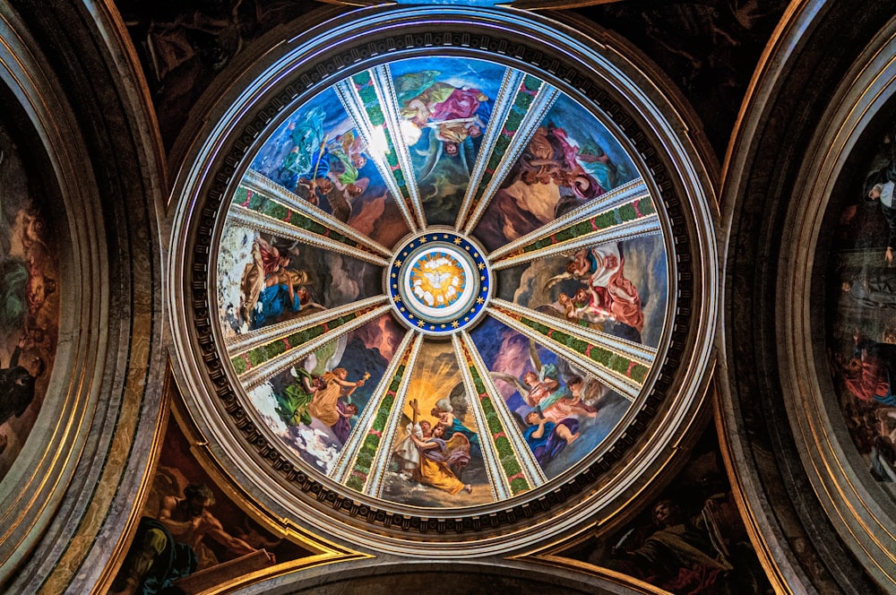 the ceiling of a church with many paintings on it