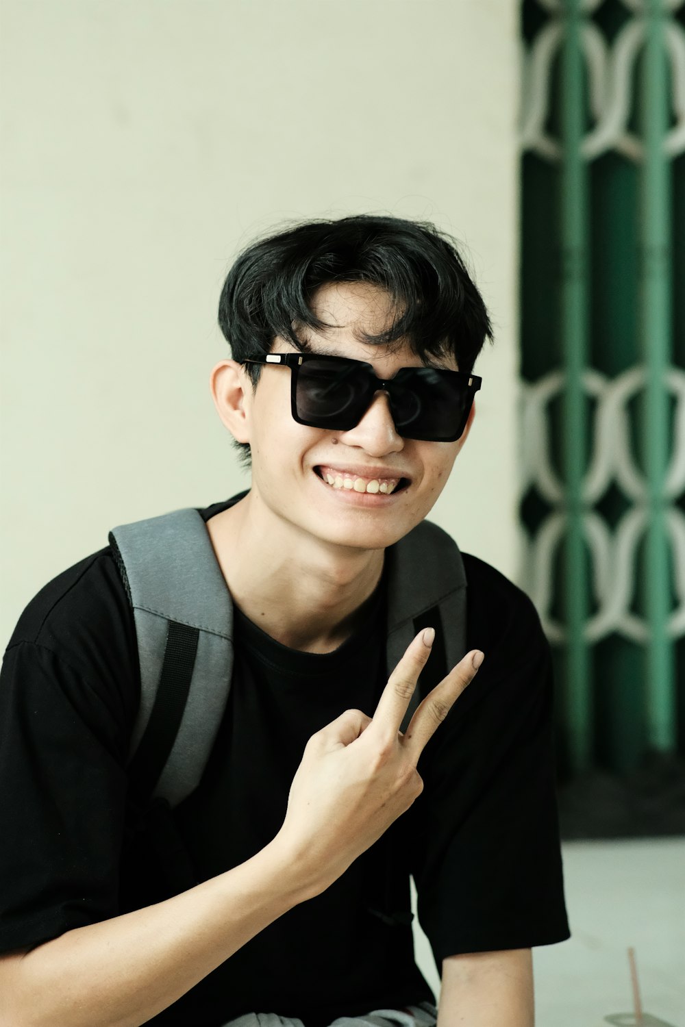 a young man wearing sunglasses and a black shirt