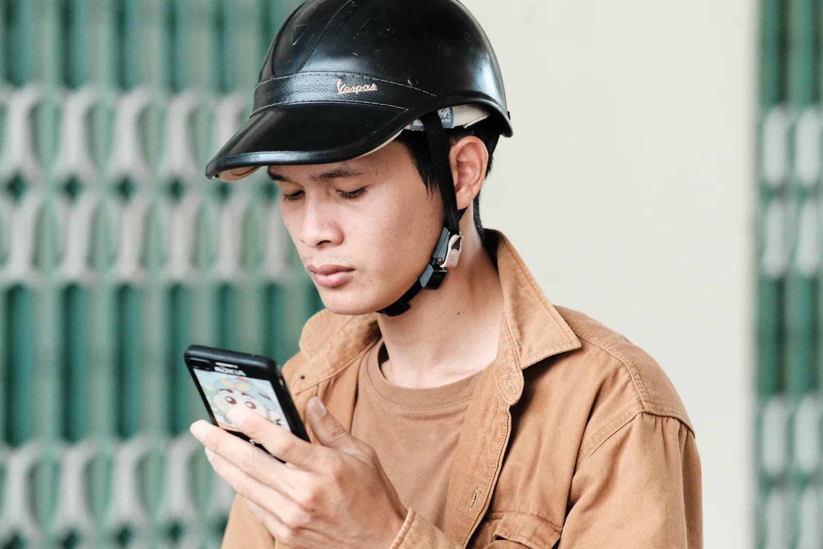 Contractor in a hard hat checking his phone on a job site