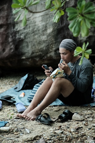 A lifestyle shot of someone enjoying Emmuny Bites outdoors on a sunny day.