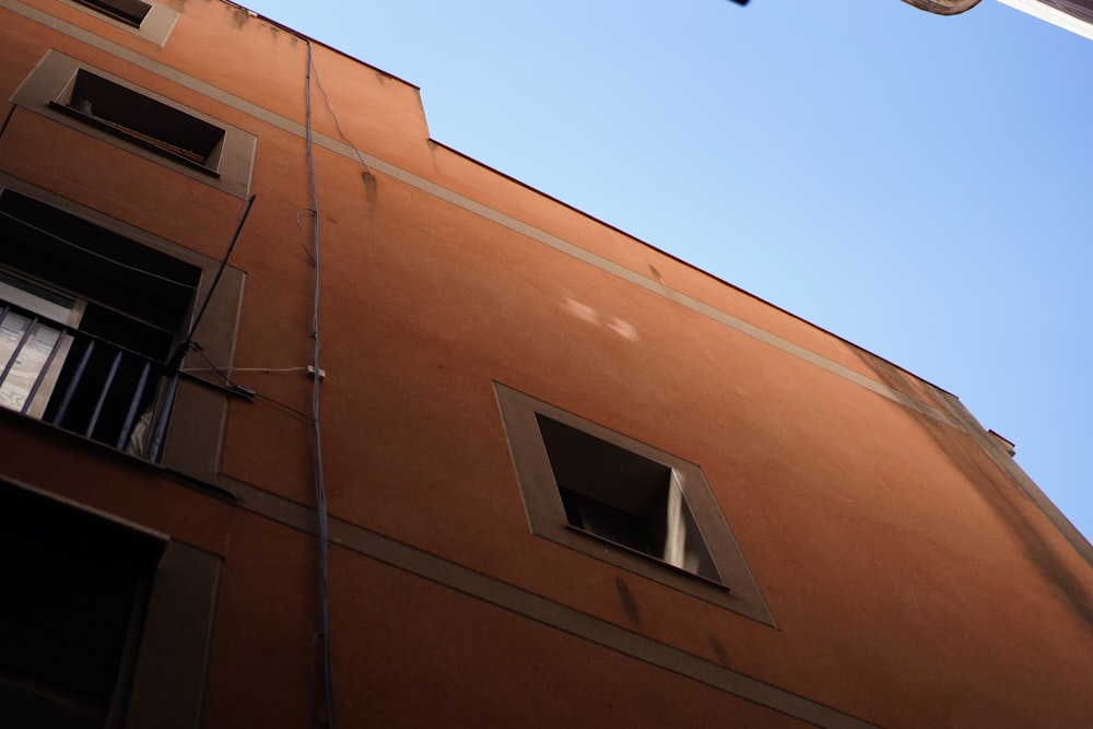 a tall building with two windows and a clock on the side of it