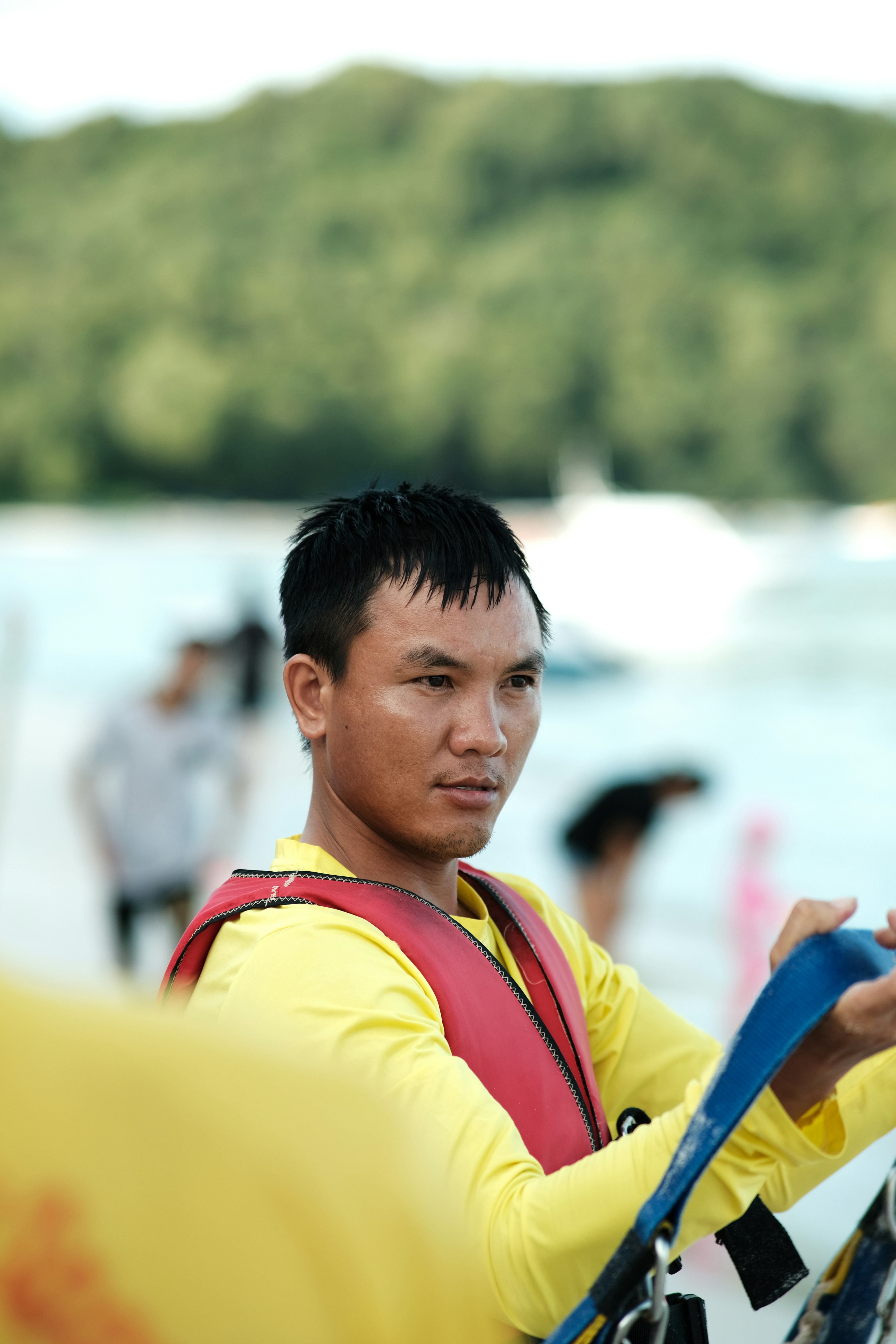 a man wearing a life jacket holding a life preserver