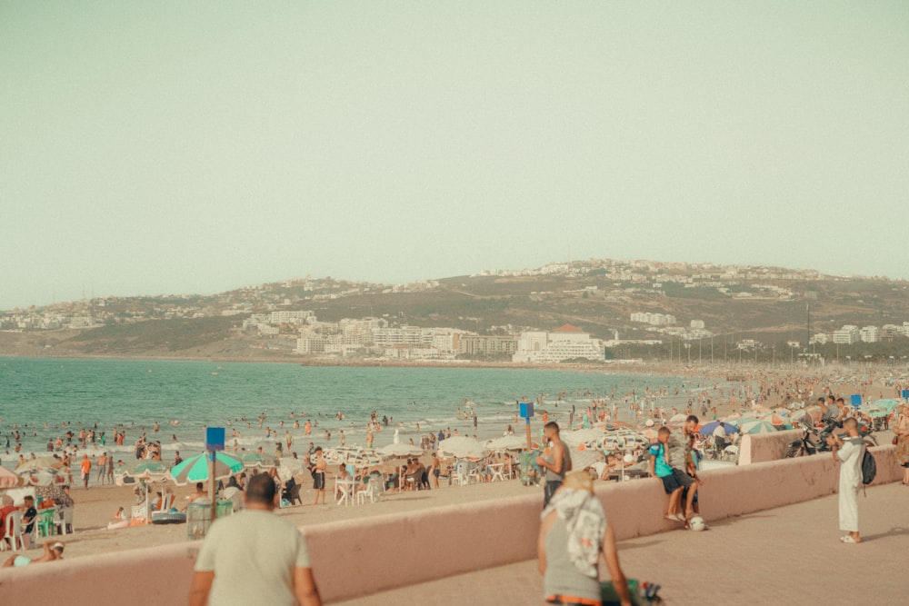 a crowded beach with a lot of people on it
