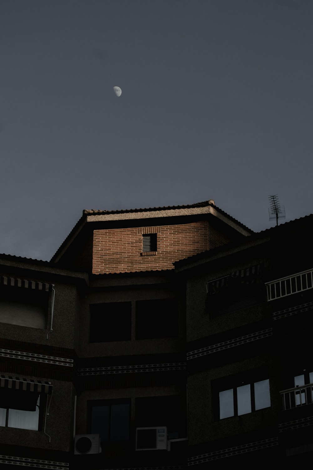 a building with a half moon in the sky