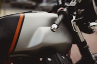 Close-up of a rider’s hands gripping the throttle, neon green accents glowing on the bike.