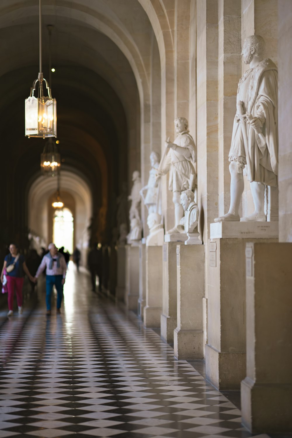 a couple of people that are standing in a hallway