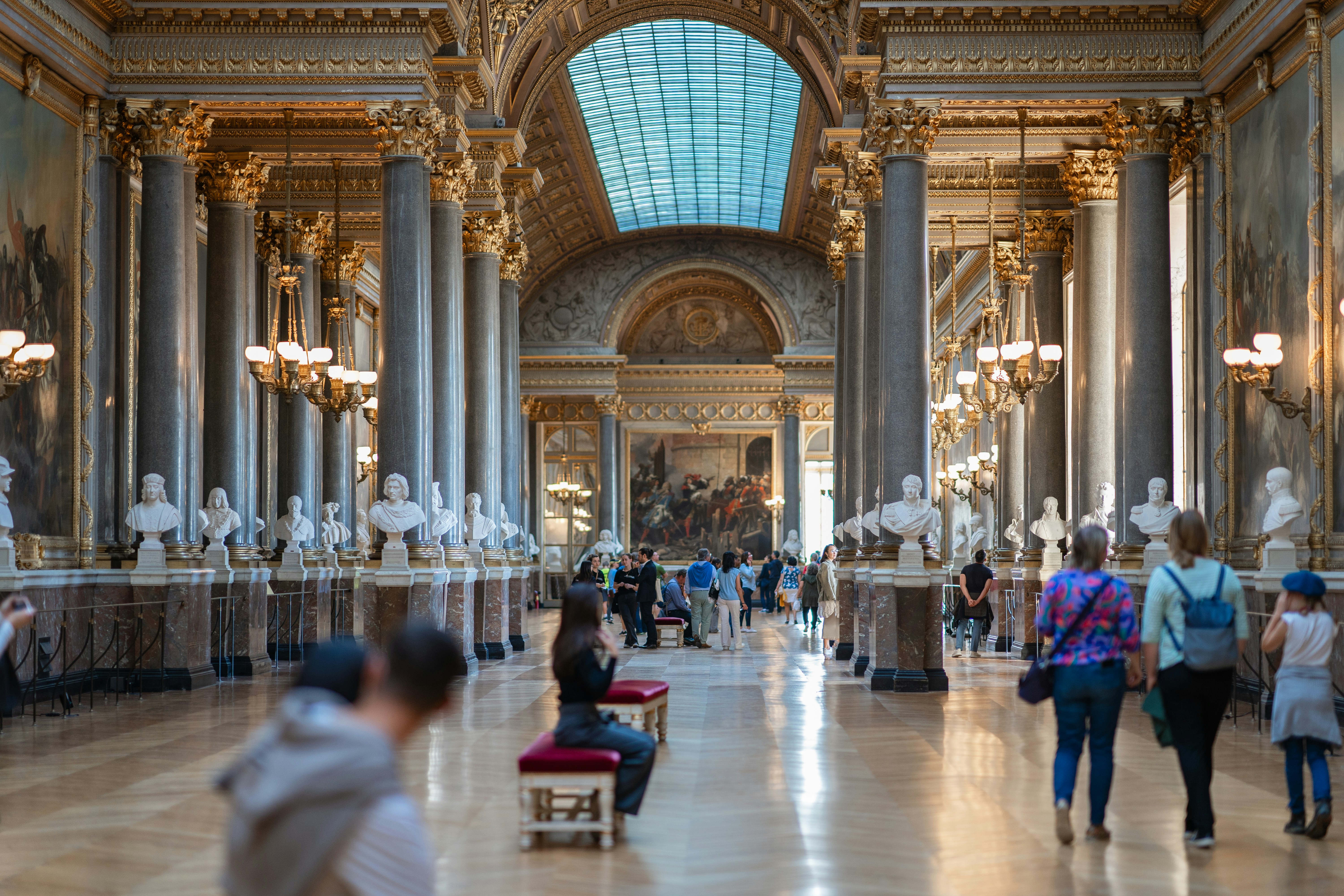 a group of people walking around a museum