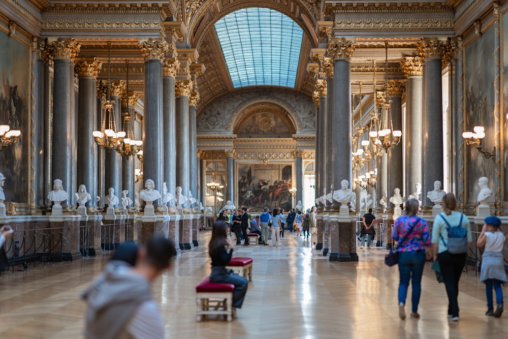 a group of people walking around a museum