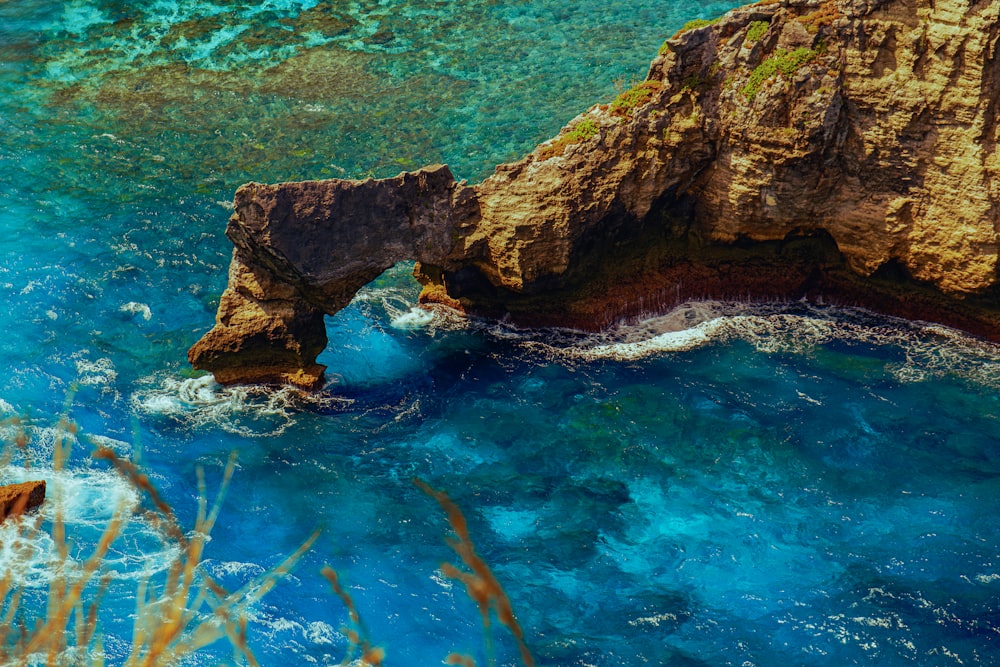 an aerial view of a rock formation in the ocean