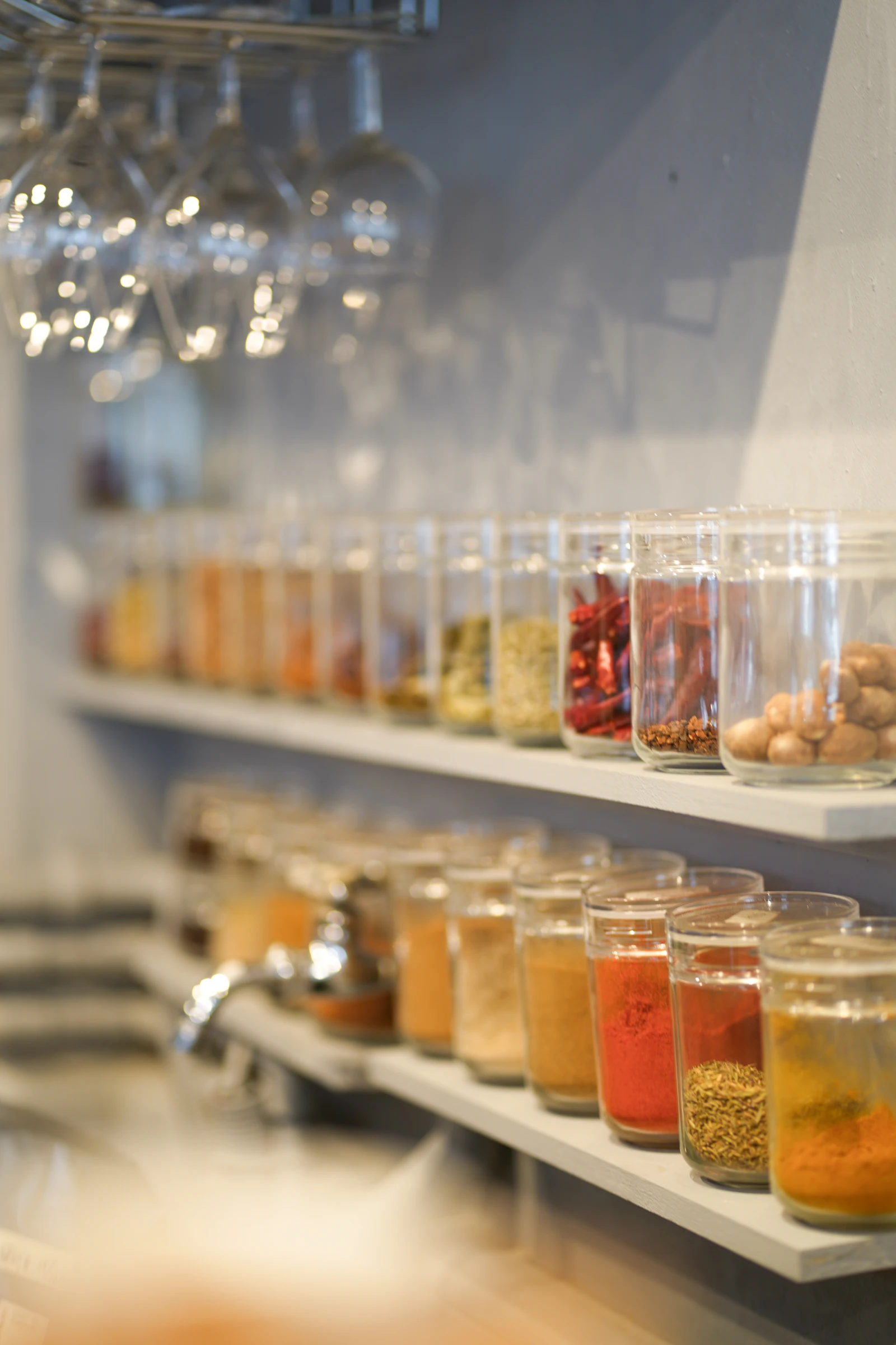 A row of jars filled with different spices