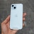A hand is holding a white smartphone with dual cameras and an Apple logo on the back.
