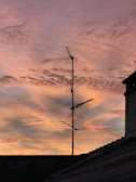Evening shot of a radio antenna silhouetted against a colorful sunset sky