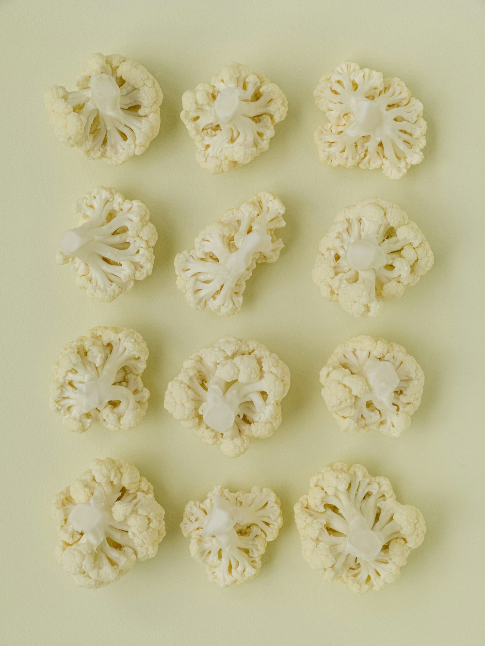 a bunch of cauliflower on a white surface