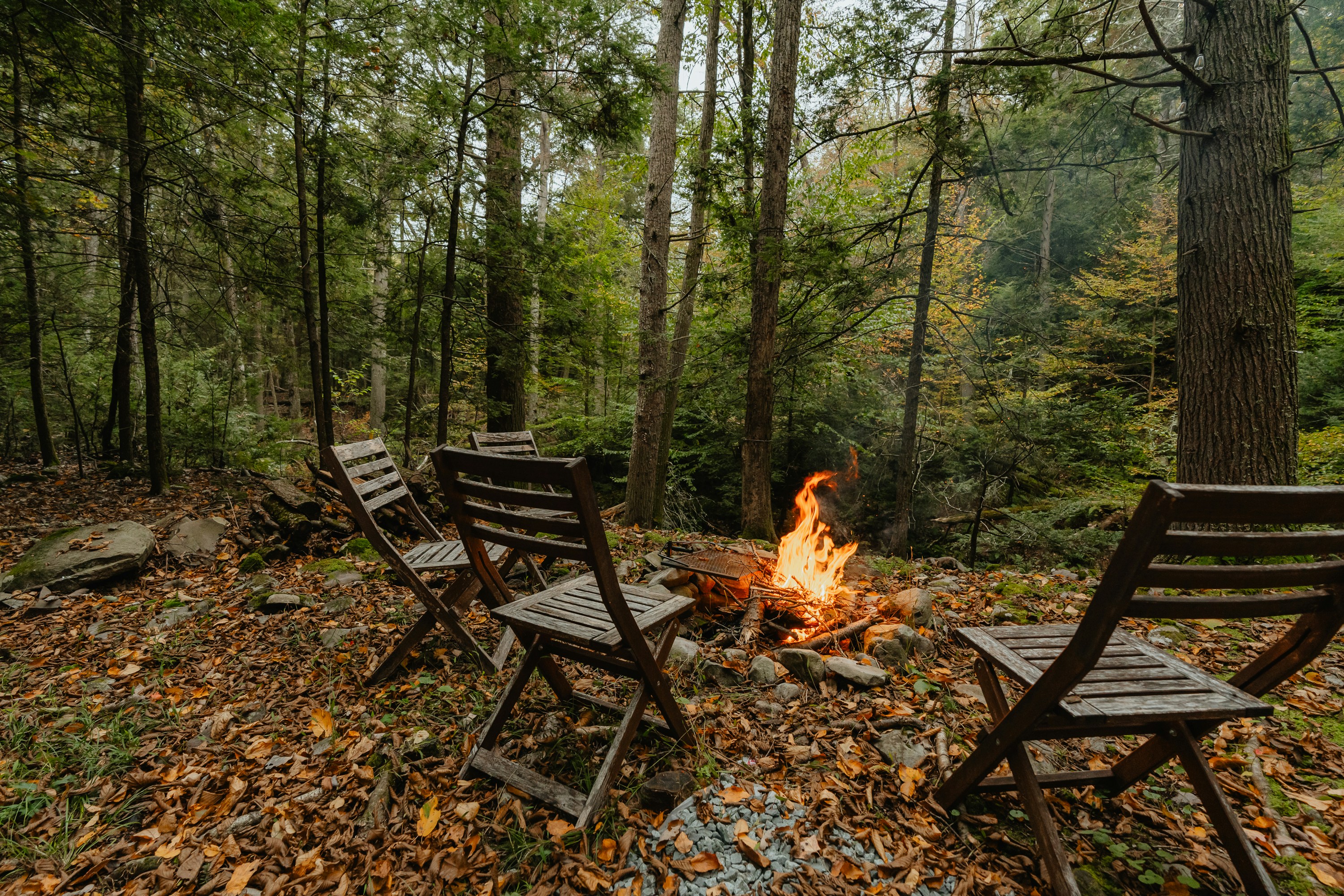cozy outdoor seating area with a fire pit and string lights - open air living space