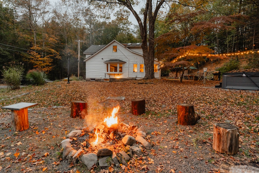 a fire pit in front of a white house