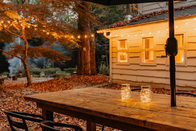 Outdoor patio scene with string lights and a DIY pallet coffee table topped with lanterns.