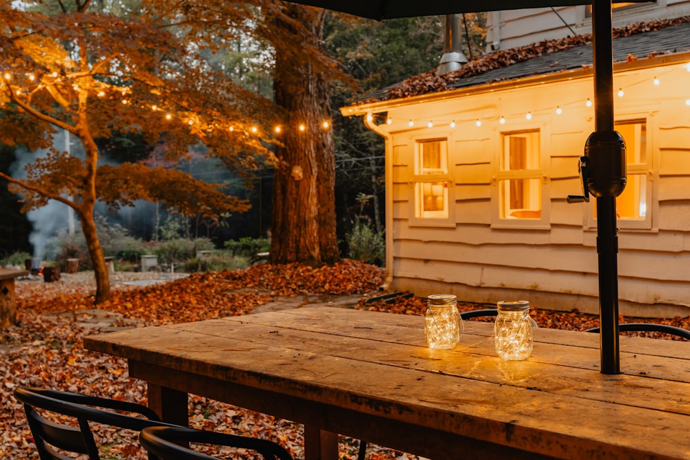 a wooden table with two mason jars sitting on top of it