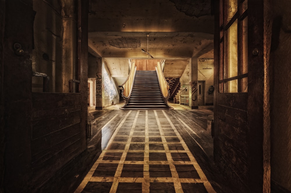 a long hallway with a set of stairs leading up to a second floor