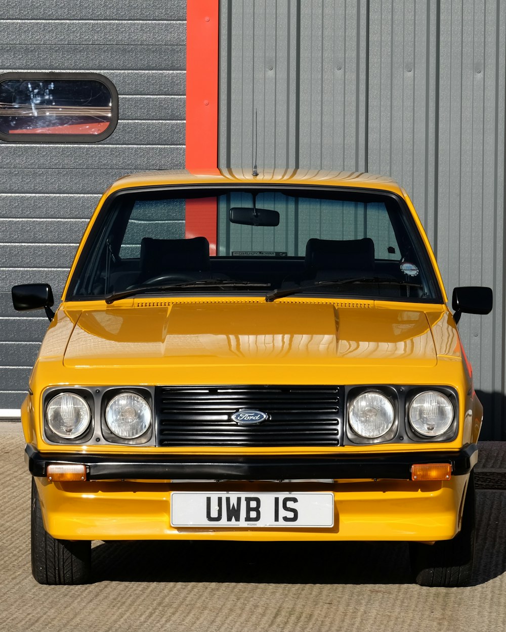 a yellow car parked in front of a building