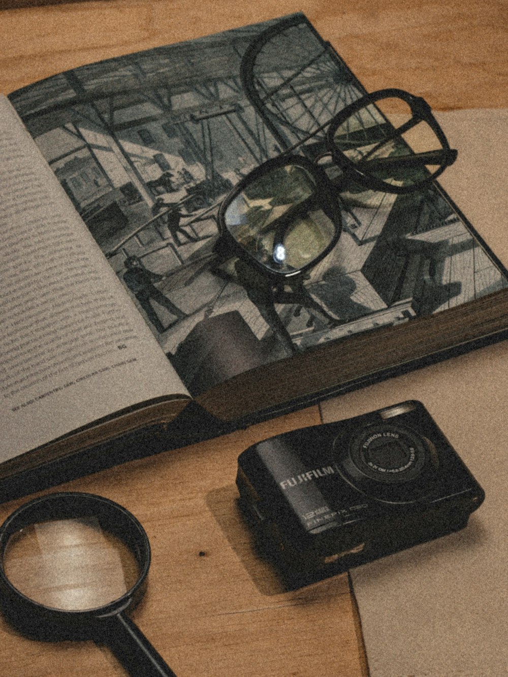 an open book with a magnifying glass on top of it