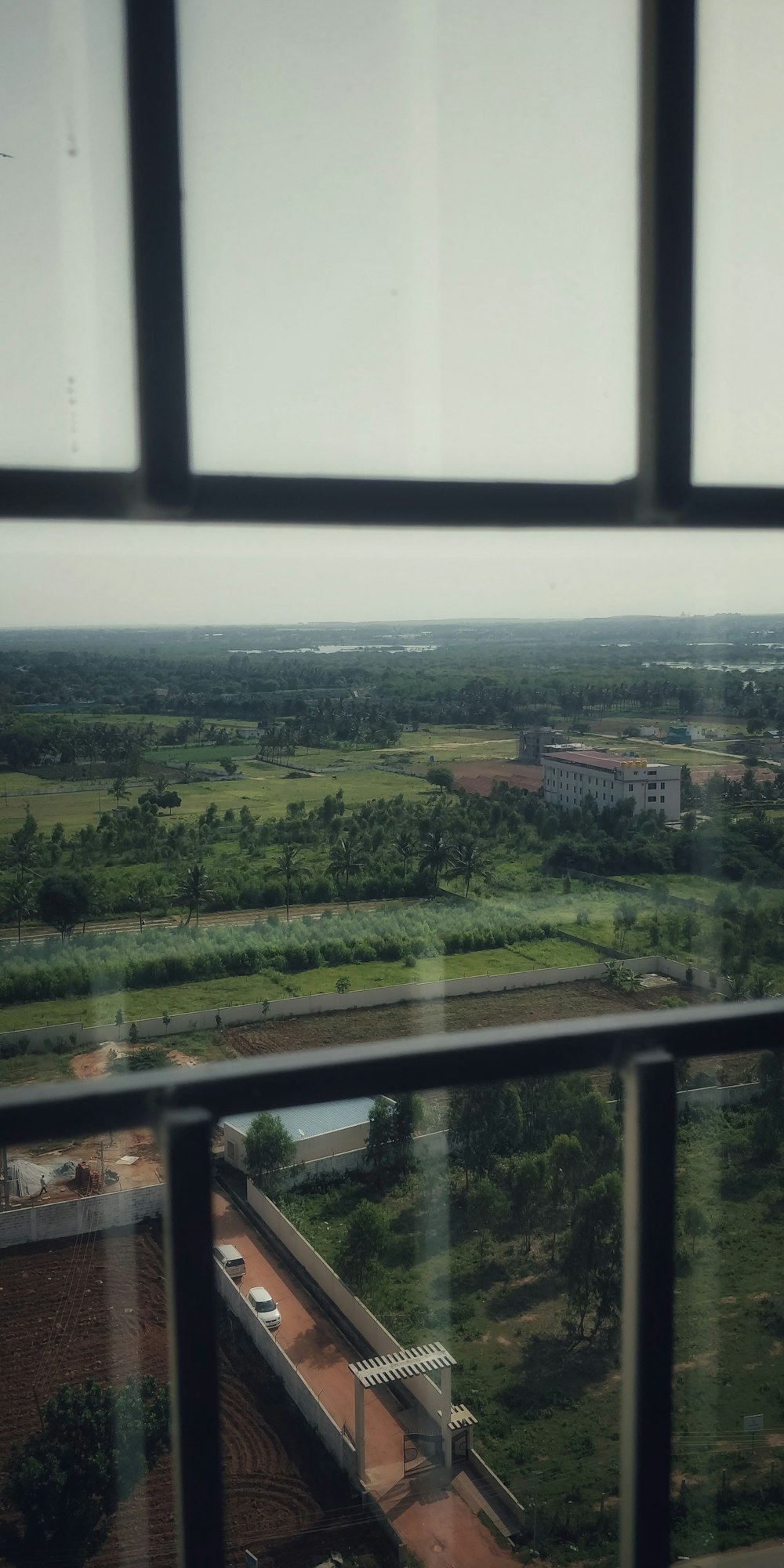 a view from a window of a building and a field