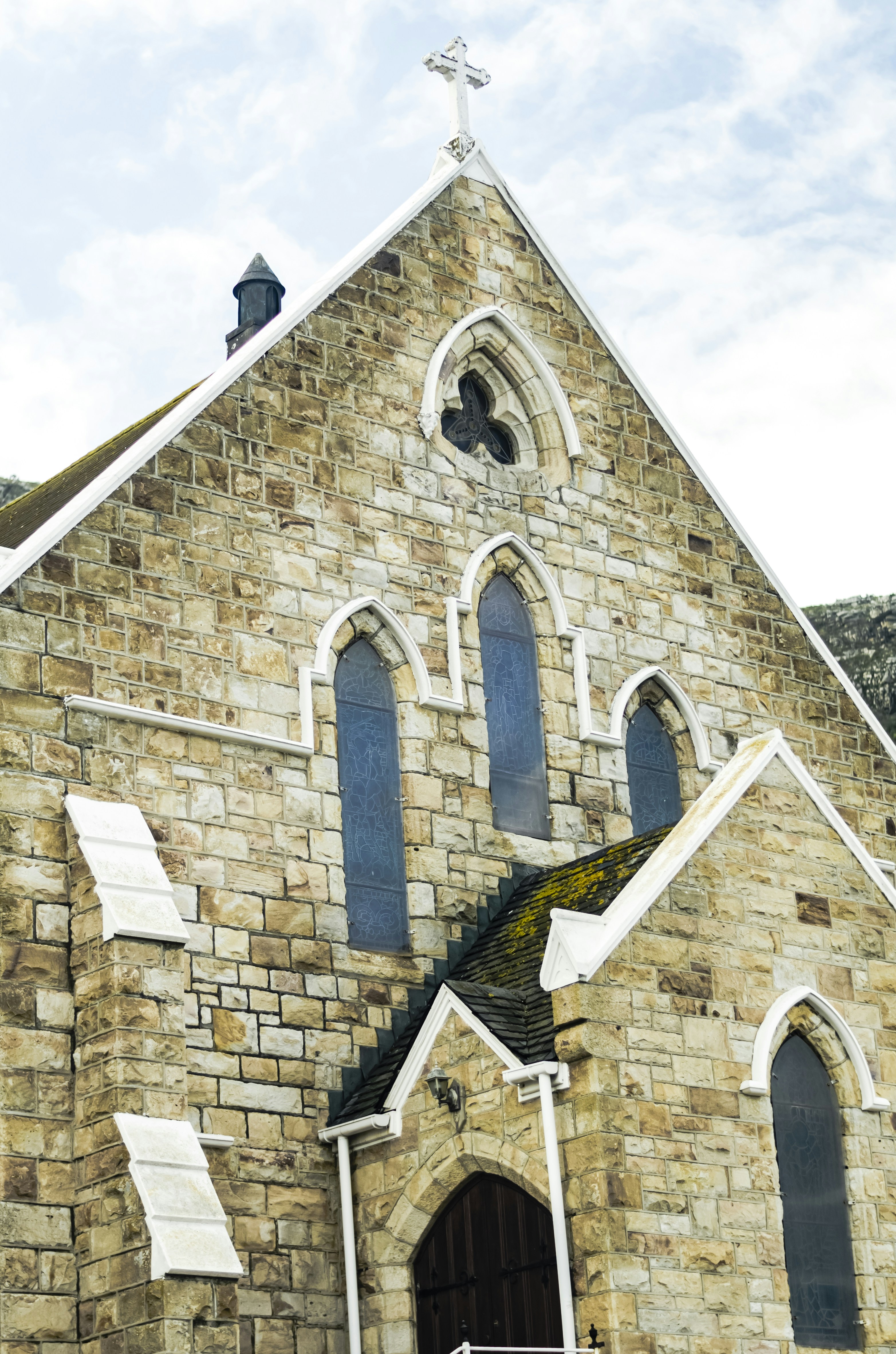 a church with a steeple and a cross on top
