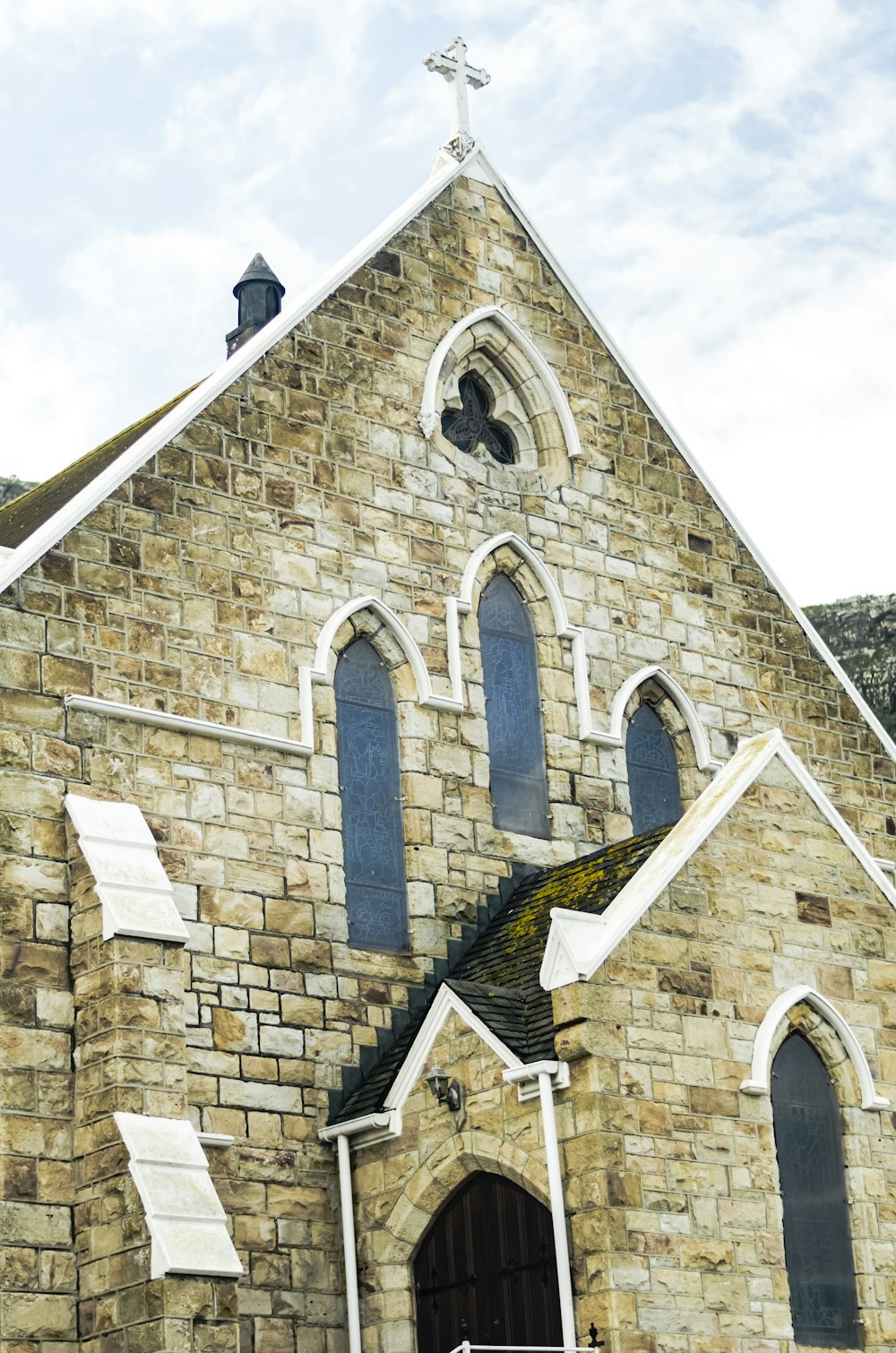 a church with a steeple and a cross on top