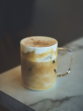 a cup of coffee sitting on top of a table