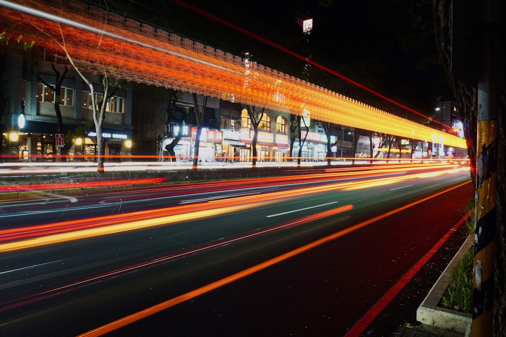 a city street filled with traffic at night