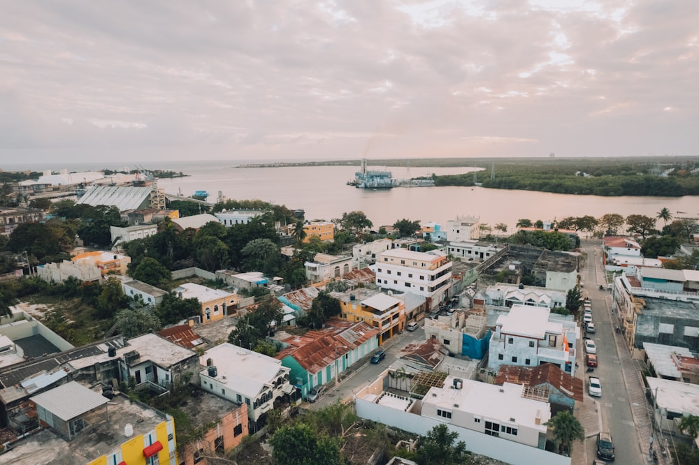 an aerial view of a city with a large body of water in the background