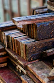 Stacks of quality wooden planks with a navy blue and yellow branded sign nearby.