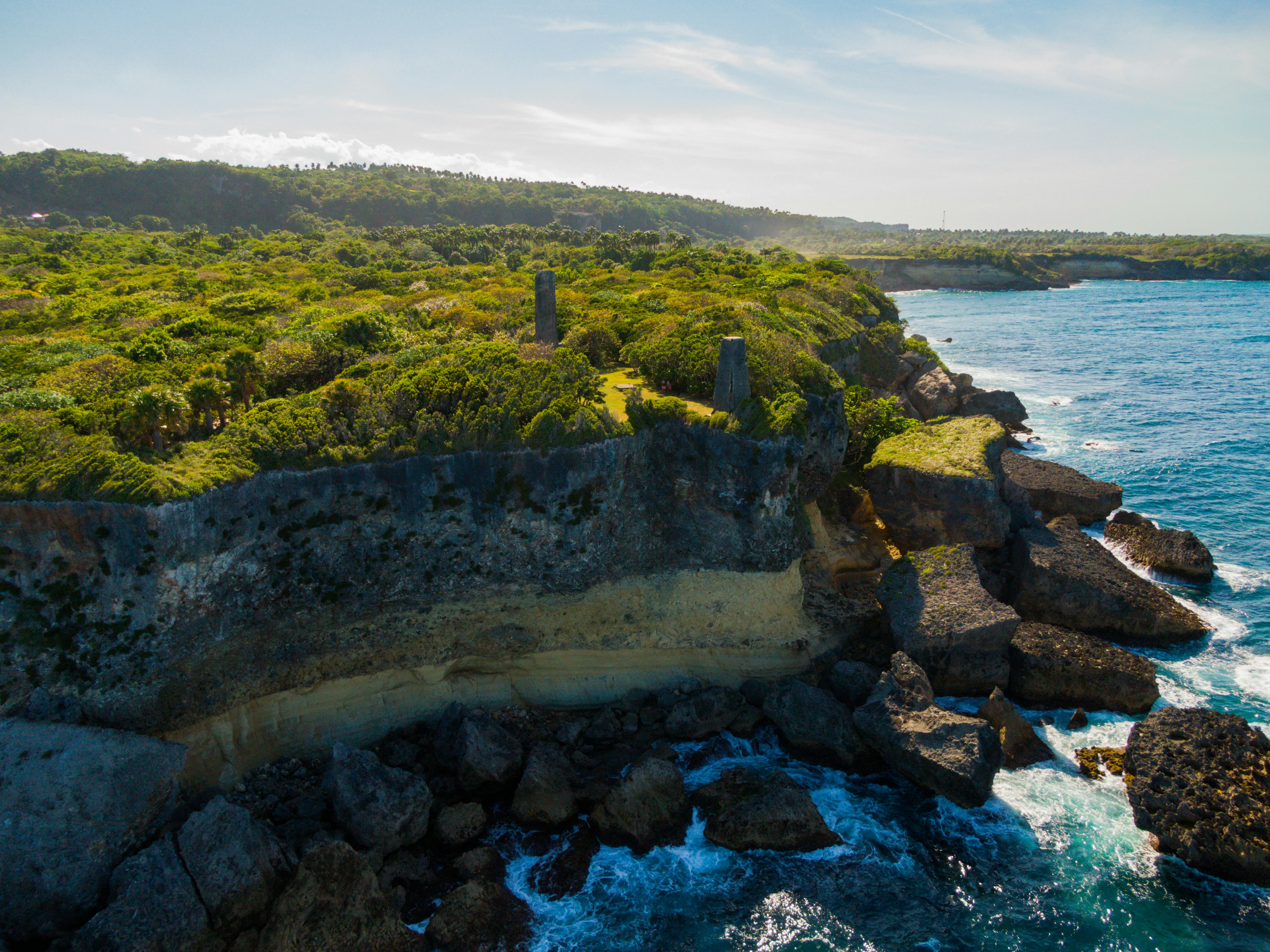 a large body of water next to a lush green hillside